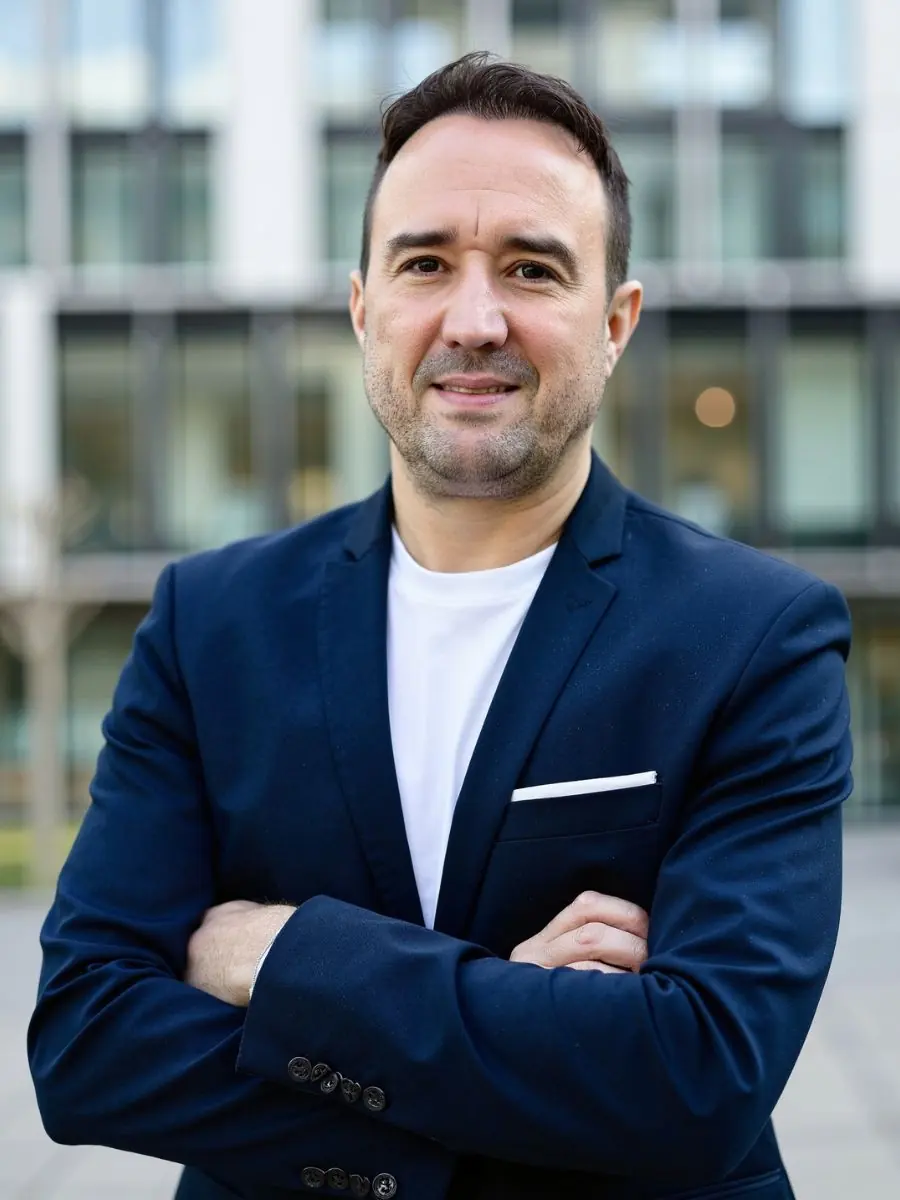 Christian Gottschling, Immobilienmakler für Ratingen, vor einer modernen Wohnanlage